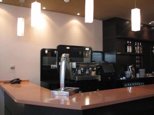 a bar with a coffee machine on a counter at Hotel Ruta de la Plata de Asturias in Pola de Lena