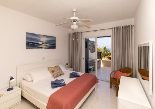 a bedroom with a bed and a balcony at 105 Kings Palace - Fabulous 2 Bed, 2 bath, Large Patio with Garden - Sea Views in Paphos City