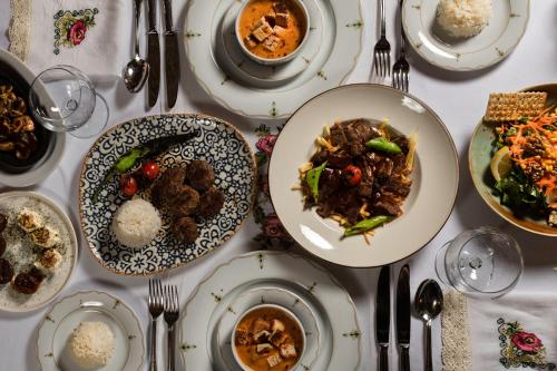 a table with plates of food on it at Cappadocia Gamirasu Cave Hotel in Urgup