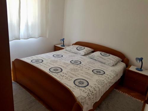 a bed with two pillows on it in a bedroom at Apartmani Luka in Korčula