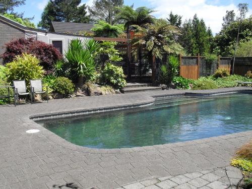 a swimming pool in the yard of a house at Cityescape in Kaimai