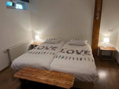 a bedroom with a large bed with white sheets at Christinahoeve Oude Deel #1 in Boskoop