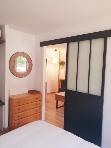 a bedroom with a black door and a wooden dresser at Mandilar Confort Panticosa in Panticosa