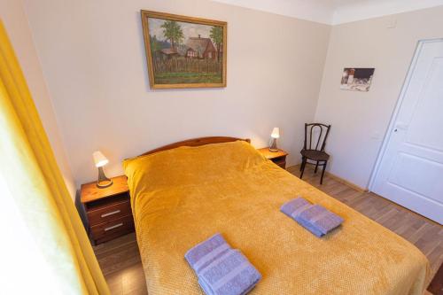 a bedroom with a bed with two pillows on it at Schneider hause in Jūrmala