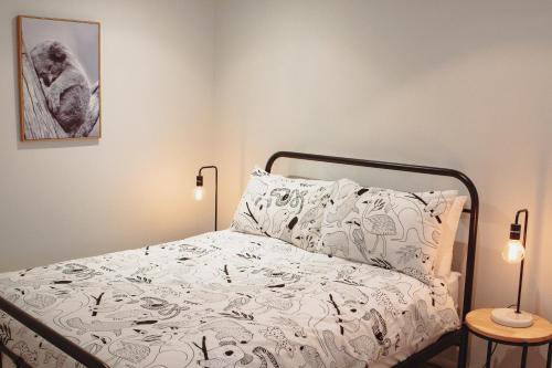 a bedroom with a bed with a white comforter at 50 HALE HAVEN in Stanthorpe