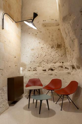 a room with two chairs and a table and a tv at PIANELLE RESORT in Matera