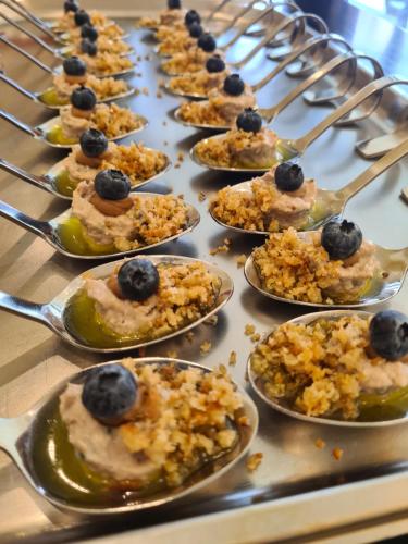 a bunch of plates of food with blueberries on them at Farmer Hotel Basedow in Basedow
