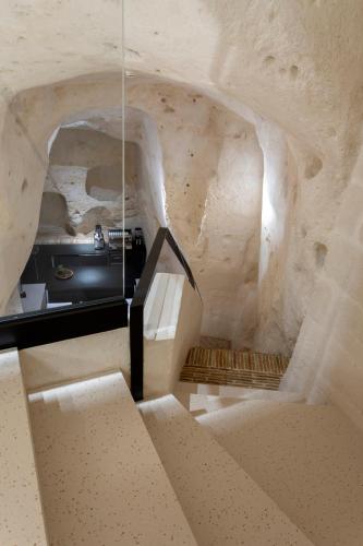 a staircase in a room with a stone wall at PIANELLE RESORT in Matera