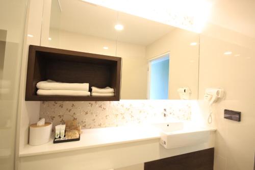 a bathroom with a sink and a mirror at River Tree Resort in Chiang Khan