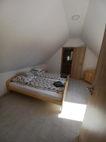 a bedroom with a bed in a attic at Fazekas Vendégház in Balatonkeresztúr