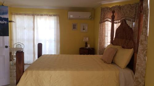 a bedroom with a large bed in a room at Eve's Rockaway Villa in Alligator Pond Village