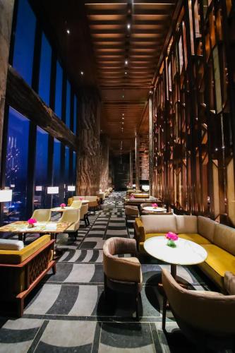 a restaurant with couches and tables and windows at Shangri-La Nanning - The tallest hotel worldwide in Shangri-La Group in Nanning