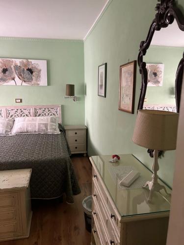 a bedroom with a bed and a desk with a lamp at Hotel Villa Liana in Florence