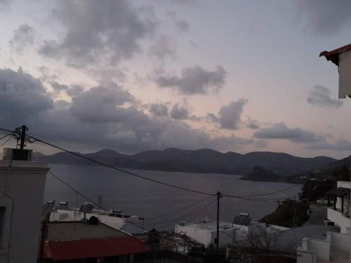 a view of a body of water from a city at poets apertment in armeos masouri in Masouri