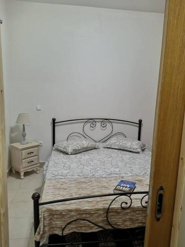 a bedroom with a bed and a remote control on it at poets apertment in armeos masouri in Masouri