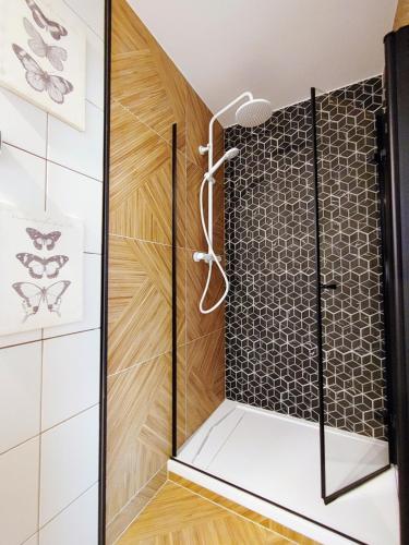a shower with a glass door in a bathroom at Bungalow Kapitański in Jastrzębia Góra
