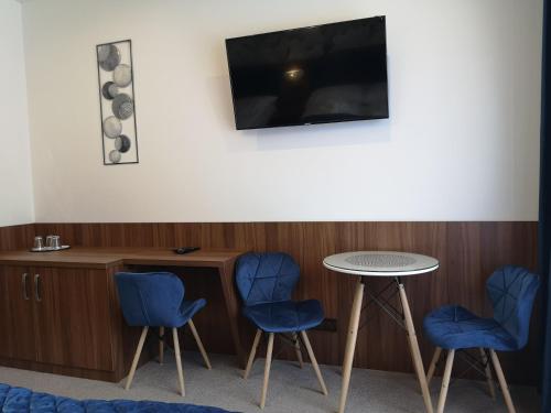 a waiting room with two blue chairs and a table at Hotel Biele Studničky Dargov in Dargov