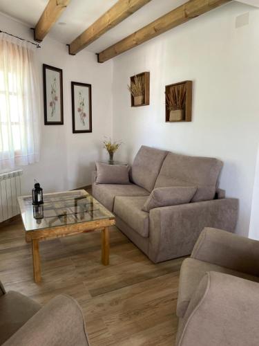 a living room with a couch and a coffee table at Vivienda Turistica Alojamiento Rural CASA IRENE II in Segura de la Sierra
