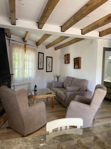 a living room with a couch and a table at Vivienda Turistica Alojamiento Rural CASA IRENE II in Segura de la Sierra