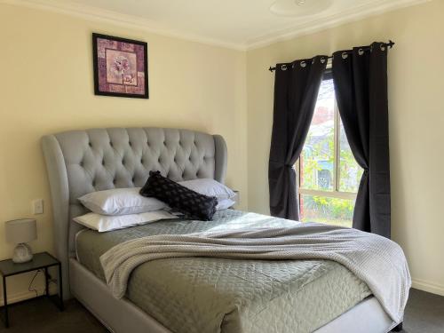 a bed in a bedroom with a window at James Court Suite in Rutherglen
