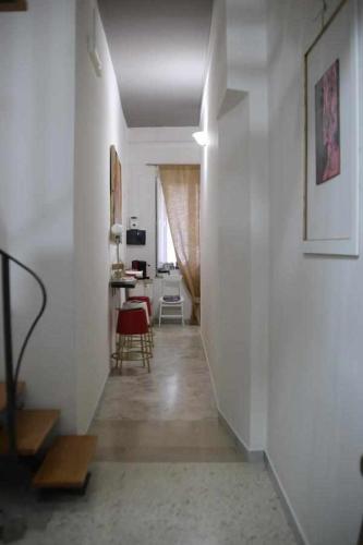 a hallway leading to a living room with white walls at Le Dimore degli Artisti in Venosa