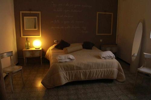 a bedroom with two beds and a lamp in it at Le Dimore degli Artisti in Venosa