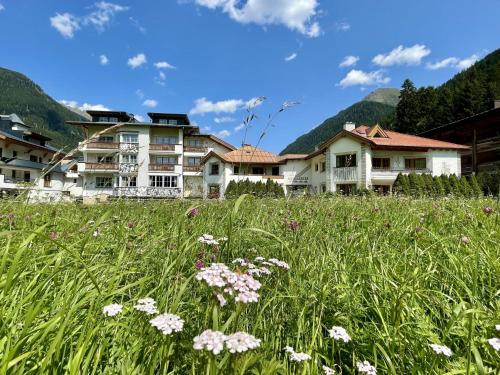 a field of flowers in front of houses at Apart Montanara in Ischgl