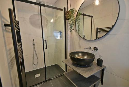a bathroom with a bowl sink and a shower at Boutique cottage set in historic town of Clitheroe in Clitheroe
