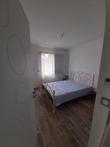 1 dormitorio con 1 cama y suelo de madera en Maison Aureilhan Mimizan Landes, en Aureilhan