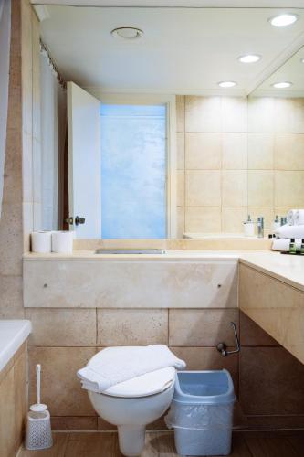 a bathroom with a toilet and a bath tub at Almog Haifa Israel Apartments מגדלי חוף הכרמל in Haifa
