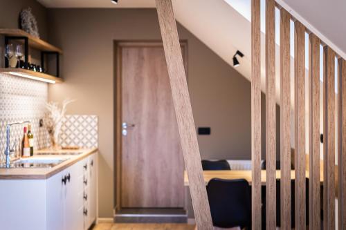 a kitchen with a staircase leading up to a door at Penzion Repanšek in Radomlje