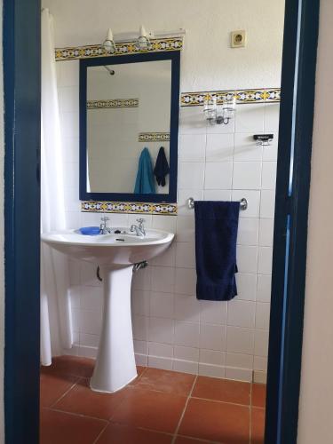 a bathroom with a sink and a mirror at Sondela Self Catering in São Martinho do Porto