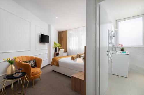 a hotel room with a bed and a table and a chair at Hotel Corner in Split