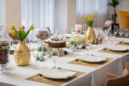 a table with wine glasses and a cake on it at Hotel Corner in Split