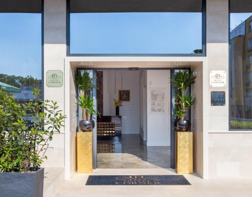 an entrance to a building with potted plants at Hotel Corner in Split