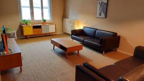 a living room with a couch and a table at Gite du Hameau in Voiteur