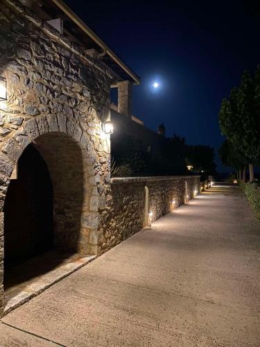 a stone wall with lights on it at night at Castello Antico Hotel in Gythio