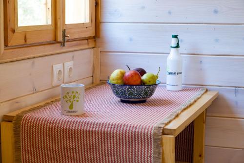 a table with a bowl of apples and a bottle of wine at Thalassa Green in Agios Nikolaos