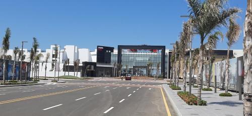 an empty street with palm trees in front of a building at Porto Said Hotel & Spa in Port Said