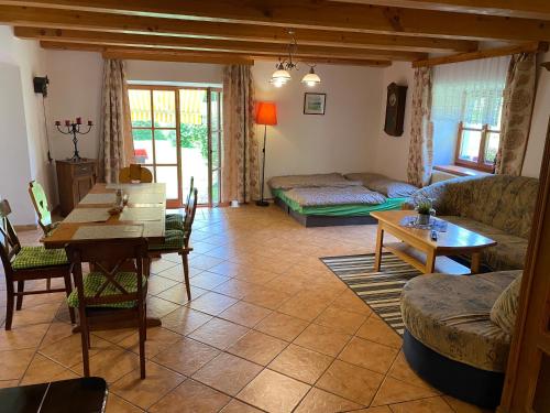 a living room with a couch and a table at Apartmán u potoka in Bujanov