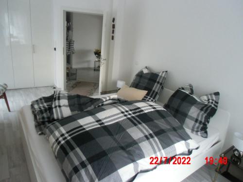 a bedroom with a bed with plaid pillows at Charmantes Loft Appartement in Haan