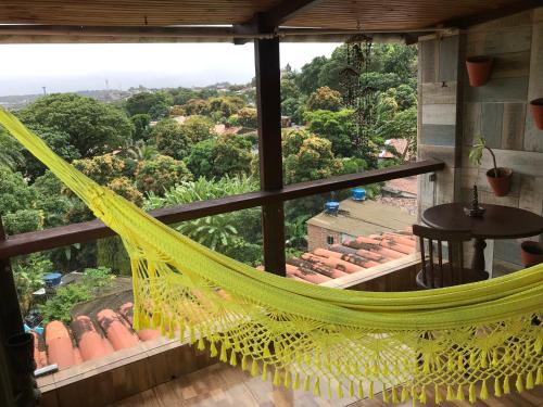 a hammock in a room with a view at Pousada Alto Astral in Olinda