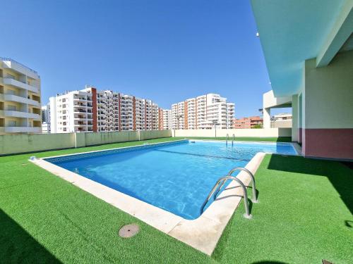 a swimming pool on the roof of a building at Apartment Rocha Vista Mar Dubai in Portimão