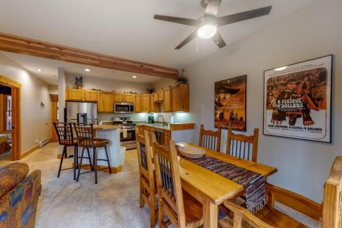 a kitchen and living room with a table and a dining room at Charming Condo Nestled In The East Keystone Resort Neighborhood, Shuttle To Ski Slopes, Outdoor Pool And Hot Tub in Dillon
