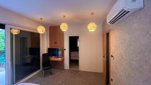 a room with two lights and a room with a television at Lohovo Villa Bukva in Otoka