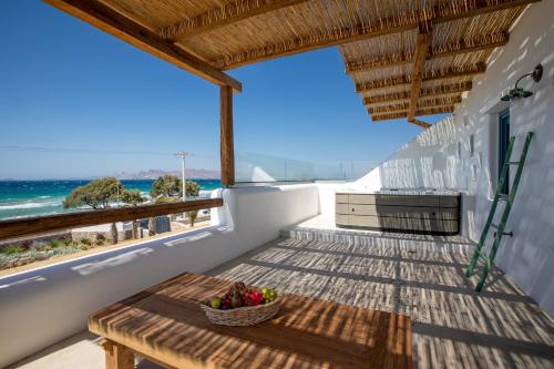 a balcony with a table and a view of the ocean at Blue Pearls-Adults Only Luxury Suites in Kos Town