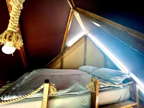 a room with a bed in a tent at Casa din "Curtea cu cai" in Borsec