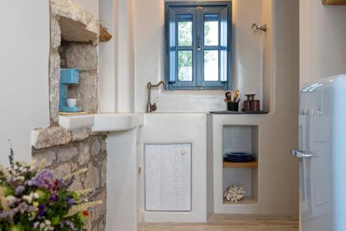 a kitchen with a sink and a window at Blue Pearls-Adults Only Luxury Suites in Kos Town
