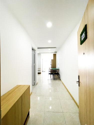 a hallway with a table and chairs in a building at NHA TRANG COMFORTZONE APARTMENT in Nha Trang
