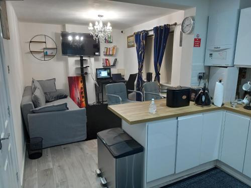 a room with a kitchen and a living room at Cozzy Accommodation in Manchester